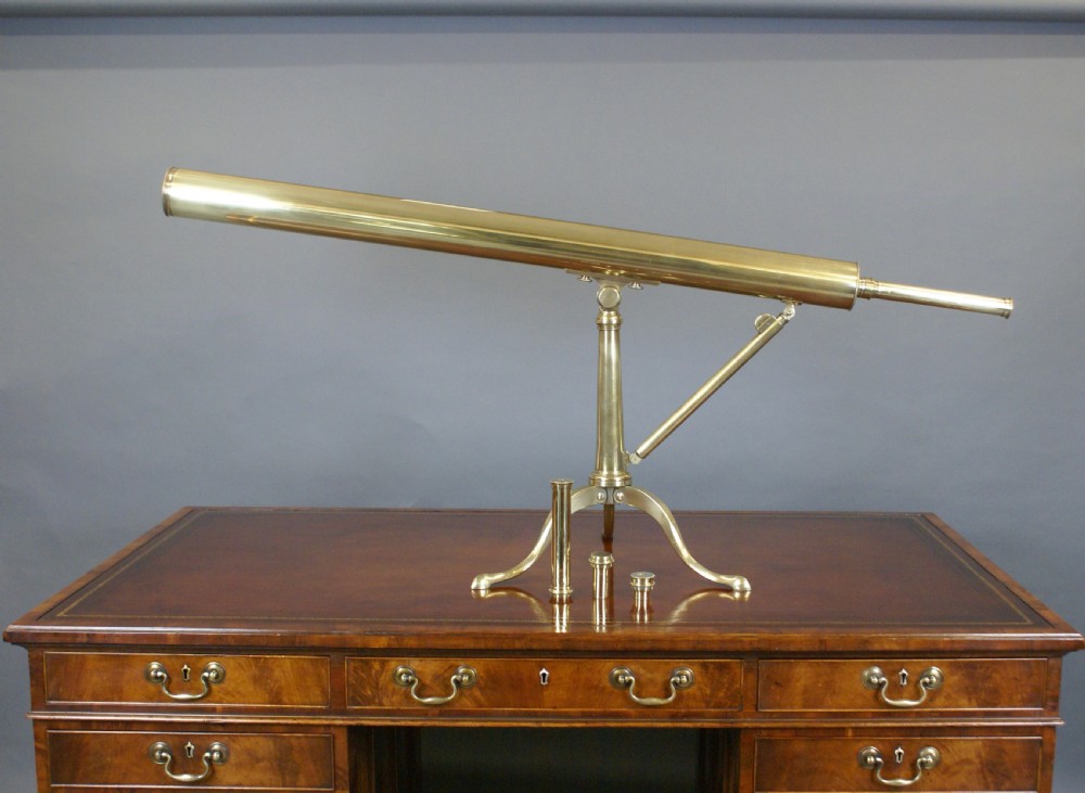A nineteenth-century Victorian brass library telescope mounted on a tripod pillar stand alongside three additional brass eyepiece attachments. View VII