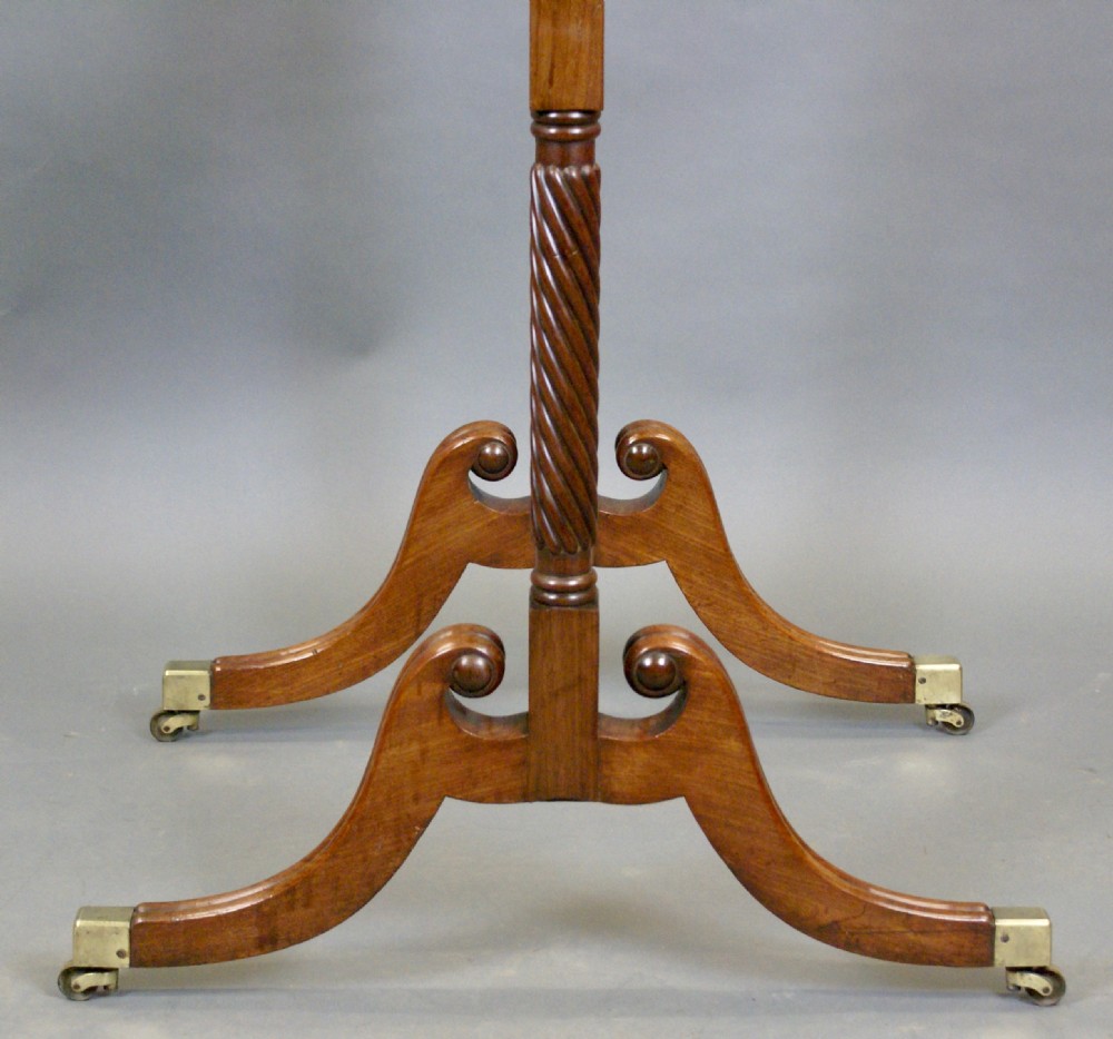 A William IV mahogany cheval mirror featuring spiral-carved support columns, a tilting rectangular glass frame, and splayed legs fitted with brass castors. View II