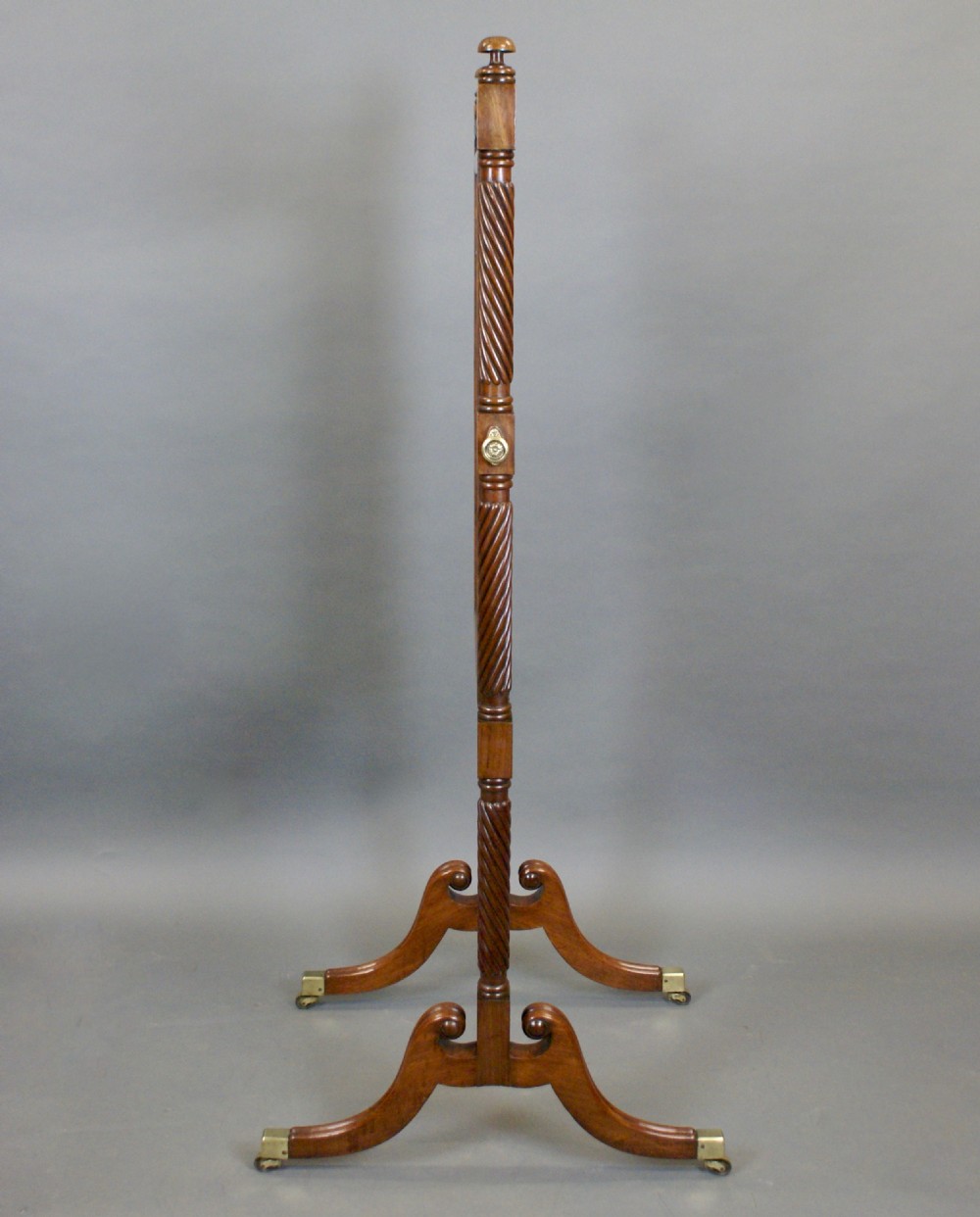 A William IV mahogany cheval mirror featuring spiral-carved support columns, a tilting rectangular glass frame, and splayed legs fitted with brass castors. View IV