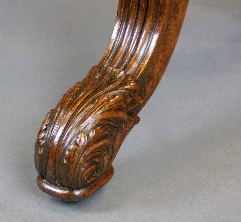 A rectangular Regency mahogany stretcher table featuring turned supports, reeded splayed legs, and a polished figured wood top. View III