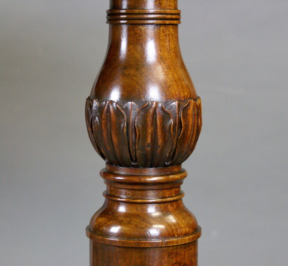 A rectangular Regency mahogany stretcher table featuring turned supports, reeded splayed legs, and a polished figured wood top. View VII