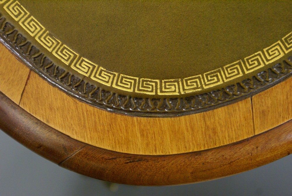 A George IV satinwood writing table featuring a green leather inset top, gilt-bronze ormolu mounts, and slender cabriole legs. View VI