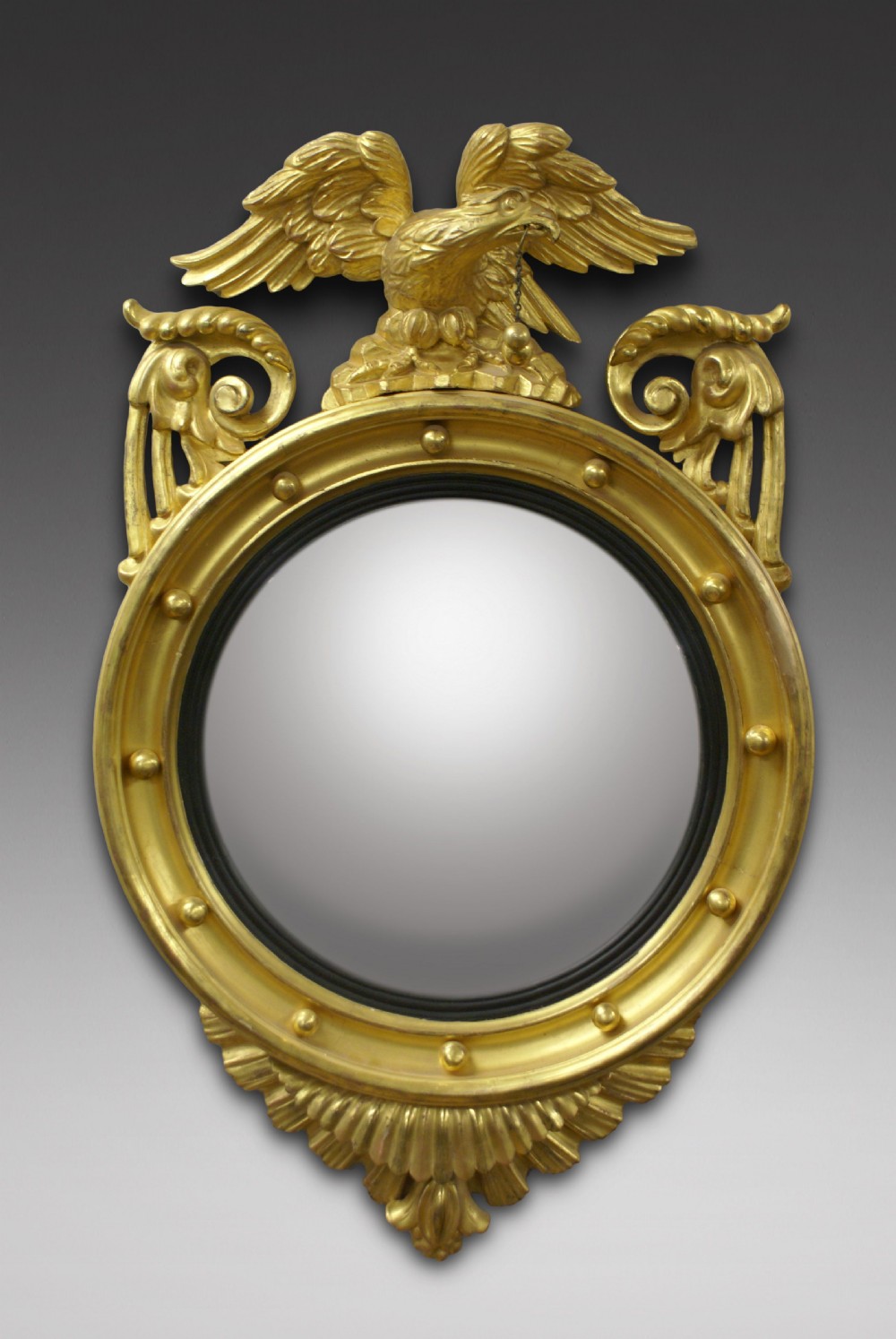 A Regency carved & gilt convex mirror