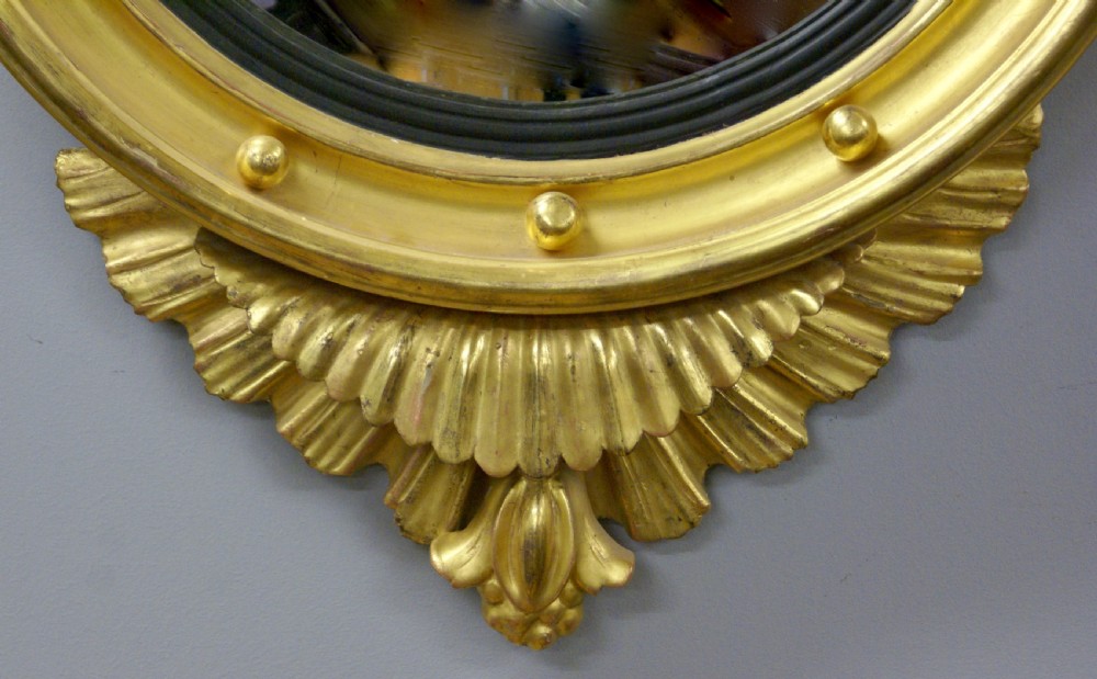 A Regency carved & gilt convex mirror View III