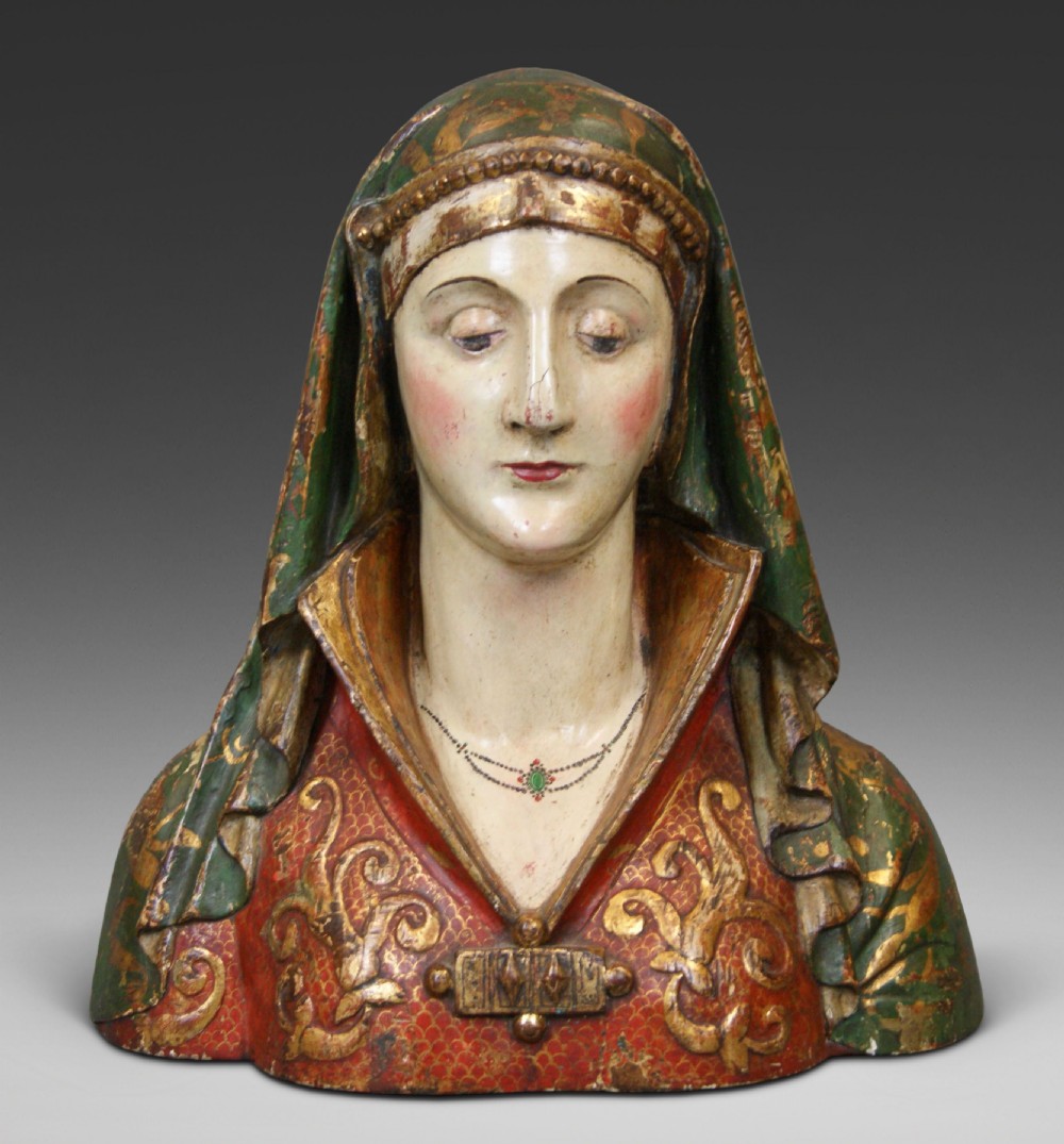 An 18th-century Italian carved wooden bust of a female saint featuring a green and gilded draped veil and a pattern-decorated red bodice.