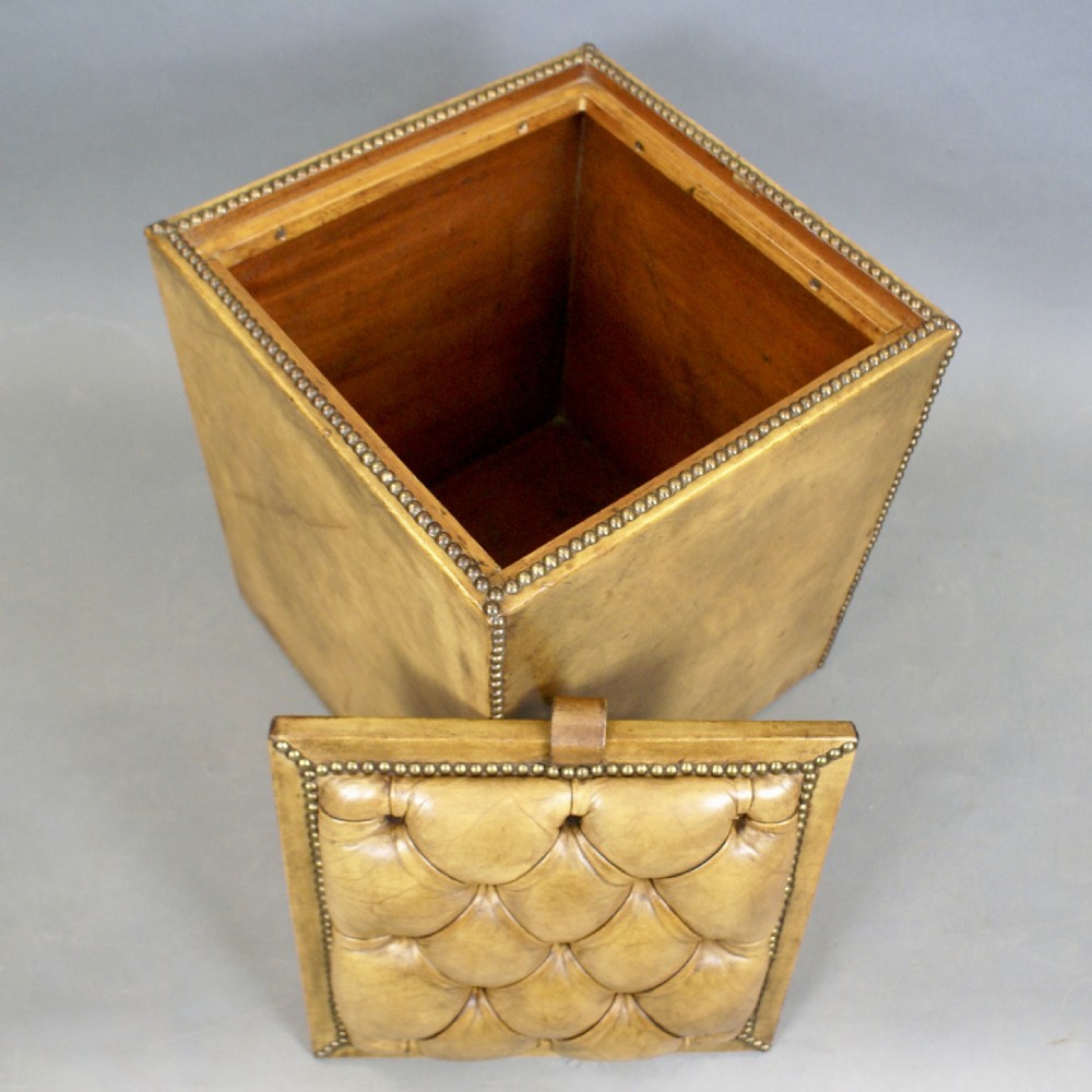 A buttoned leather upholstered ottoman View IV