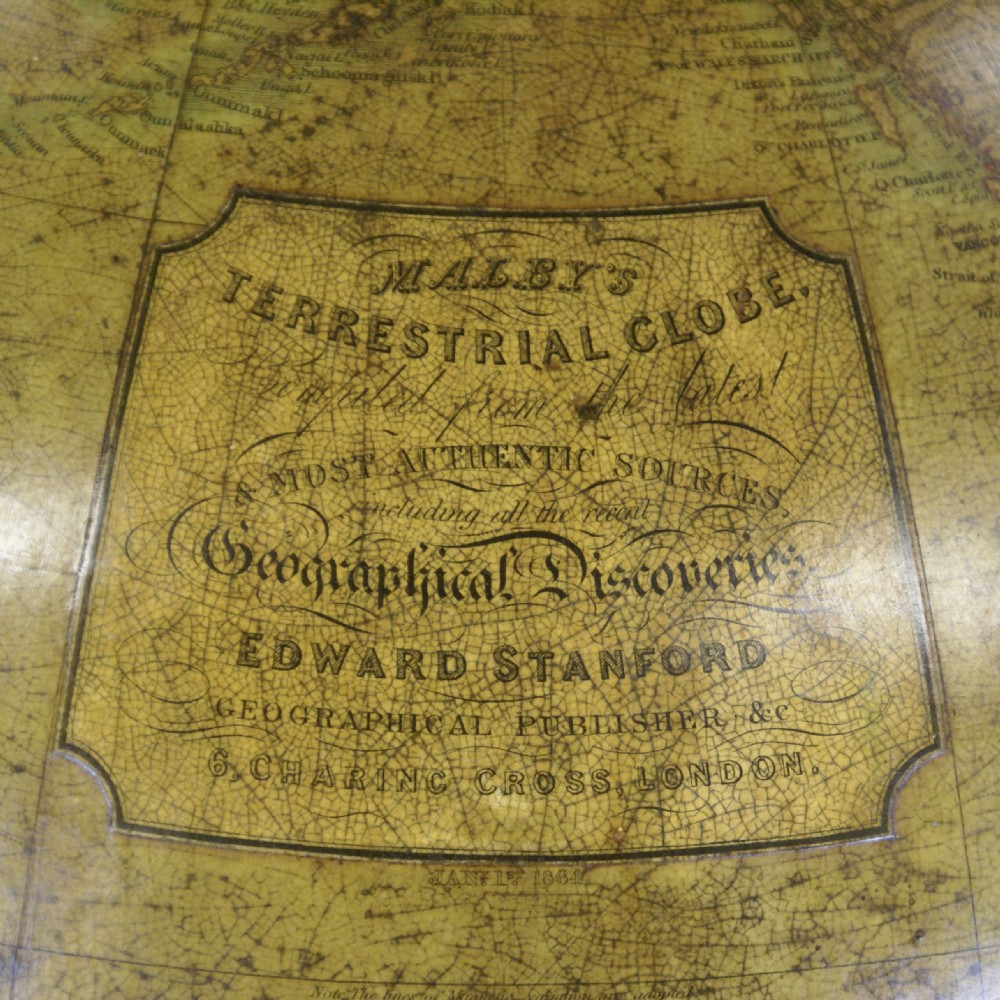 A Victorian floor-standing terrestrial library globe housed within a turned mahogany four-legged stand with a brass meridian and central compass. View III