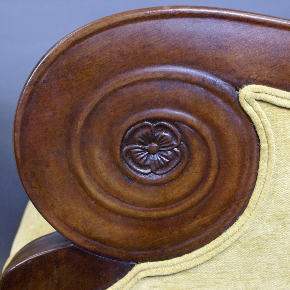 A pair of antique mahogany library armchairs featuring bold scroll arms and yellow fabric upholstery. View II