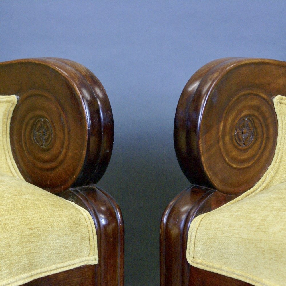 A pair of antique mahogany library armchairs featuring bold scroll arms and yellow fabric upholstery. View VII