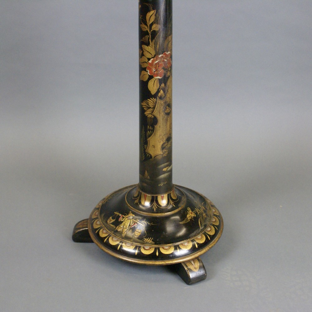 A tall black lacquered standard lamp featuring painted gold and red floral motifs on a turned column and circular base. View II