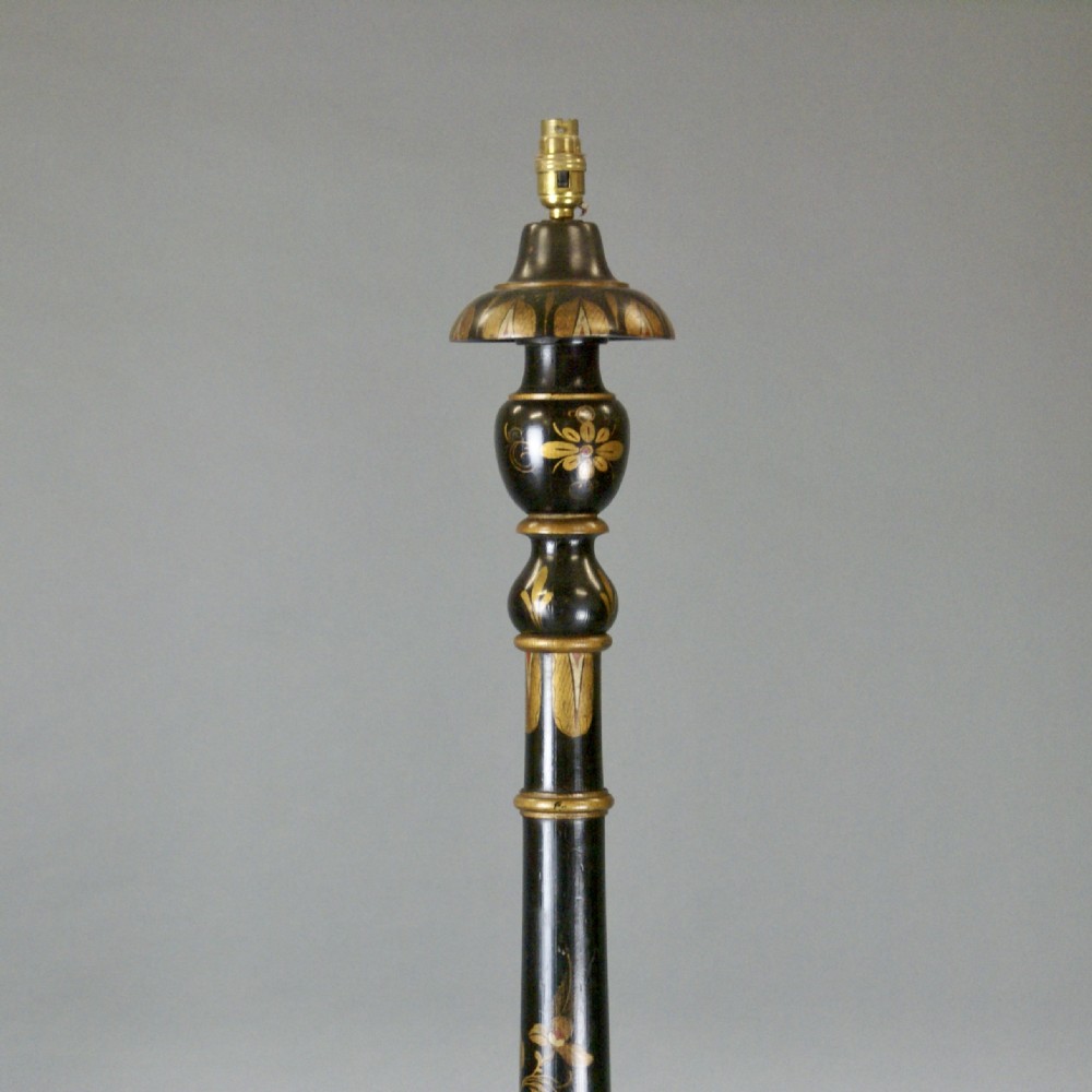 A tall black lacquered standard lamp featuring painted gold and red floral motifs on a turned column and circular base. View III