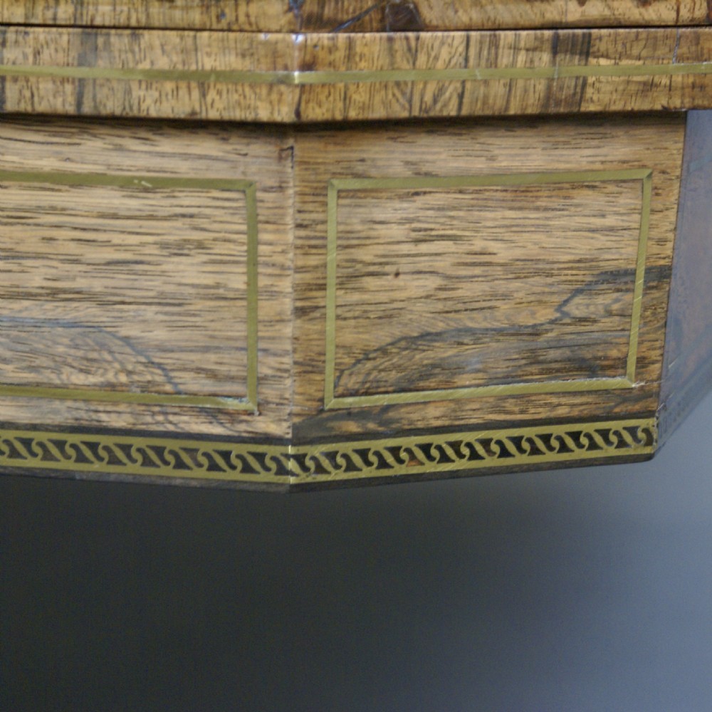A Regency rosewood fold-over card table featuring brass inlay, a central pedestal stem, and four splayed legs with brass castors. View III