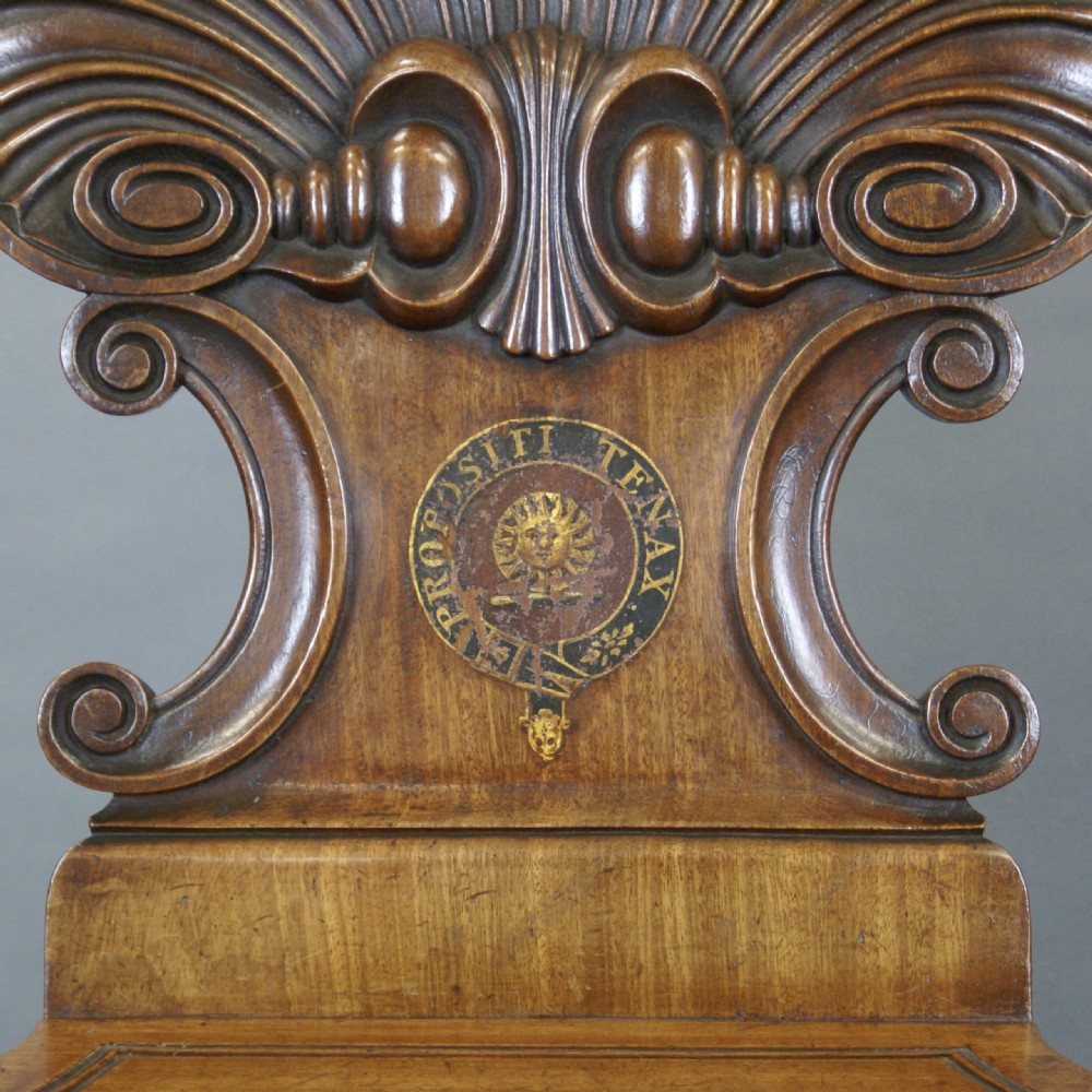 A pair of carved mahogany hall chairs featuring scalloped shell backs with painted crests and reeded front legs. View IV