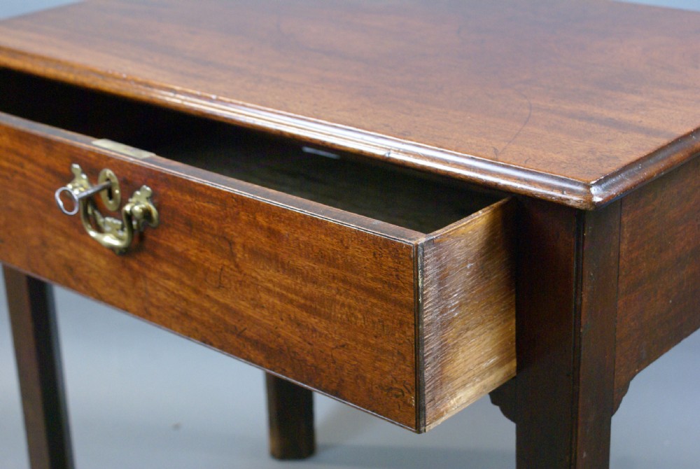 An 18th-century mahogany side table featuring a single drawer with a central brass handle and four straight legs. View VI