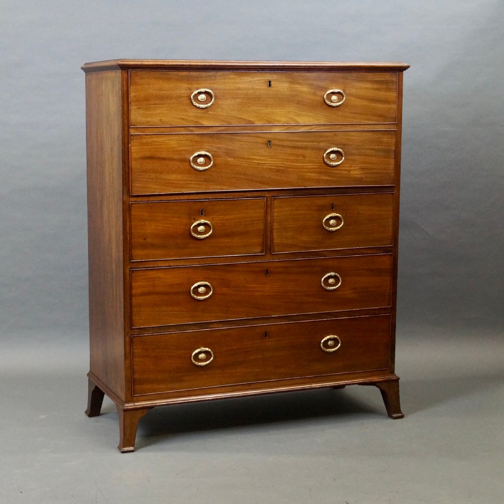 An antique mahogany secretaire chest of drawers featuring brass oval backplate handles, cockbeaded drawer edges, and bracket feet. View III