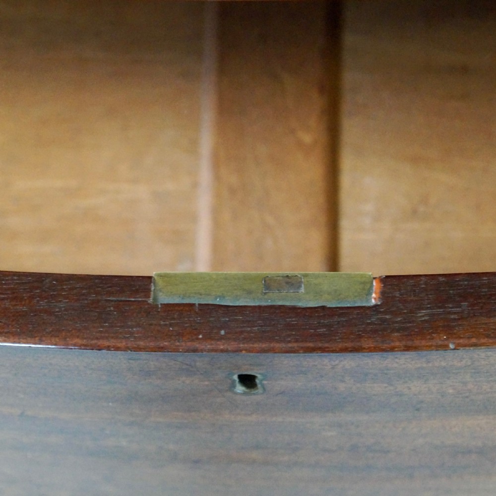 A George III bow-fronted mahogany chest featuring three graduated long drawers with turned wooden knobs and bracket feet. View VIII