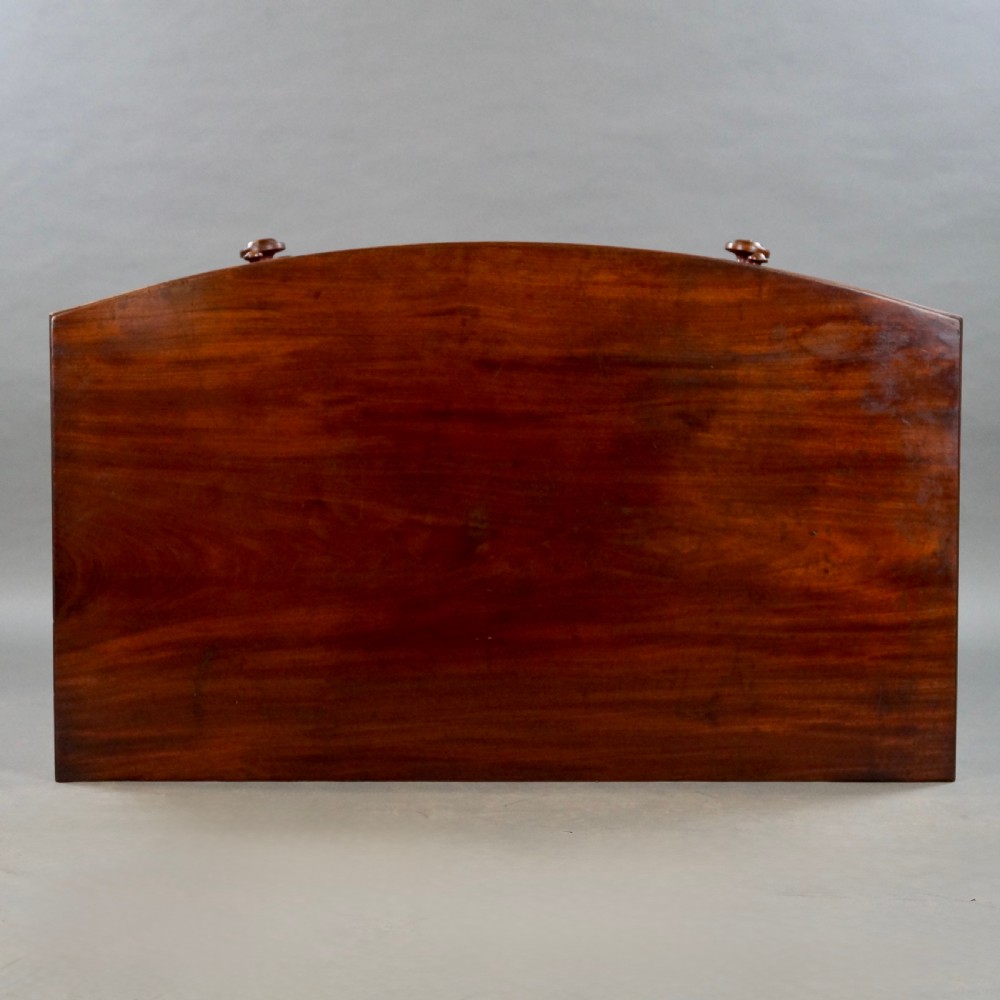A George III bow-fronted mahogany chest featuring three graduated long drawers with turned wooden knobs and bracket feet. View IX