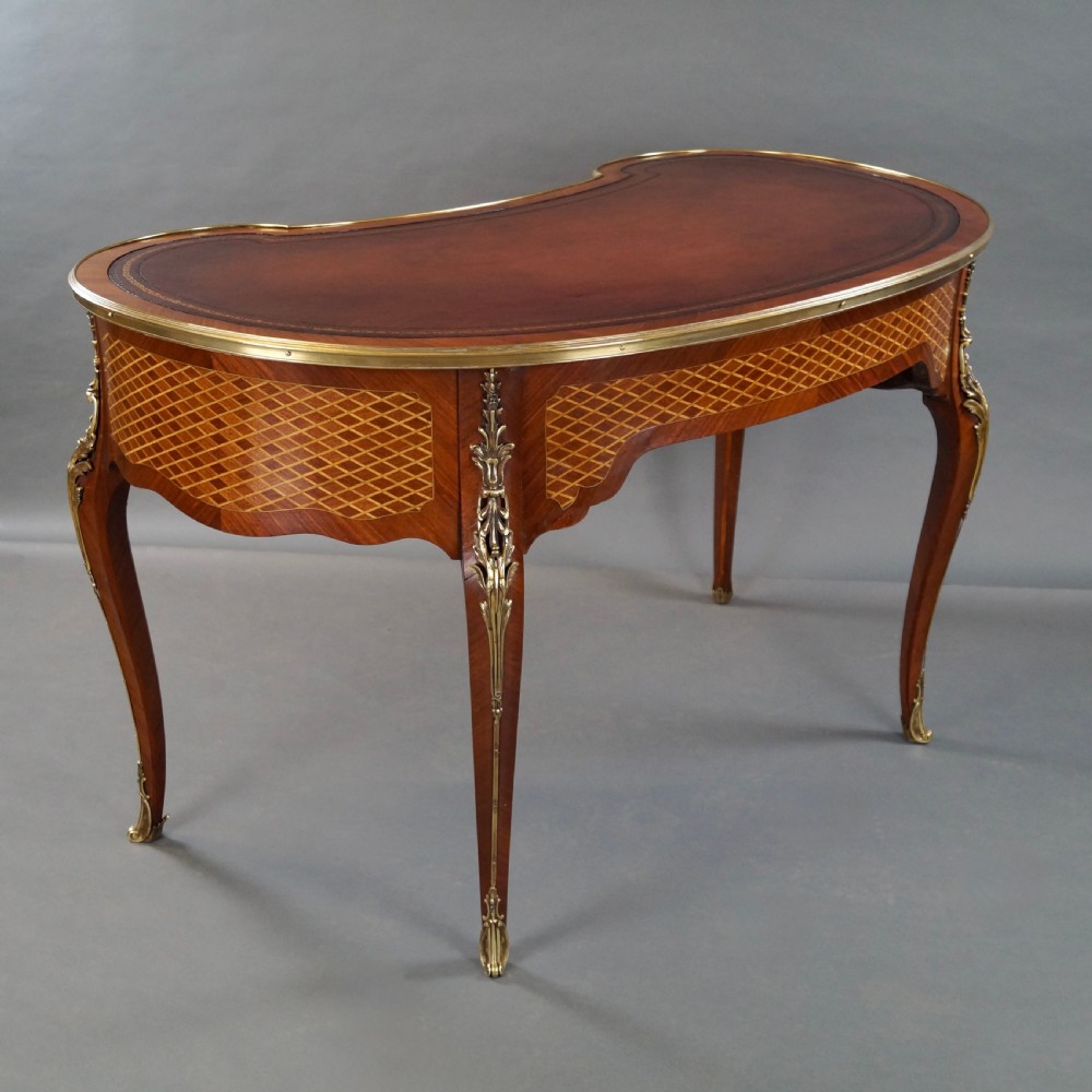 A French Louis XV style kidney-shaped writing desk featuring a brown leather top, parquetry veneer, gilded mounts, and cabriole legs. View III