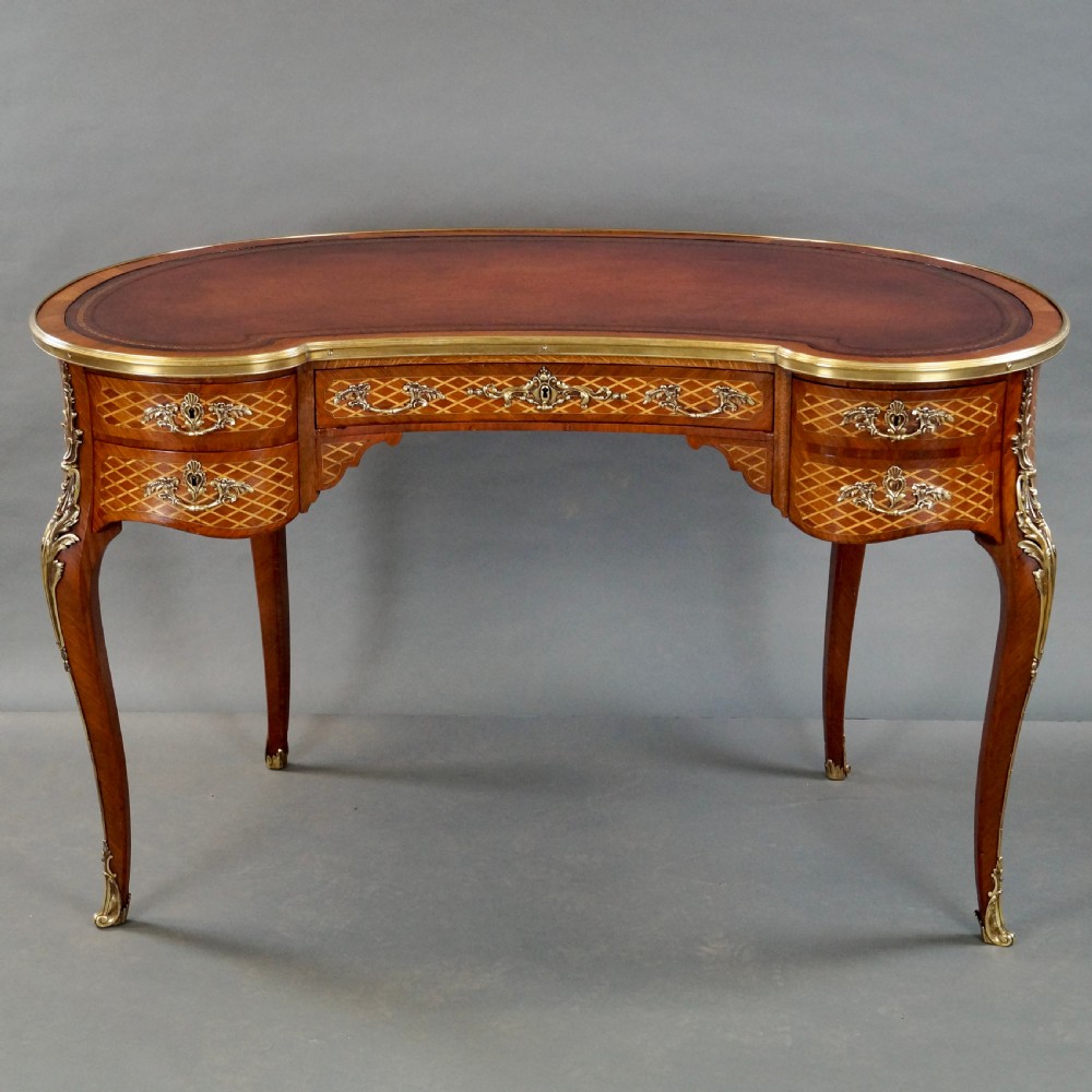 A French Louis XV style kidney-shaped writing desk featuring a brown leather top, parquetry veneer, gilded mounts, and cabriole legs. View VII