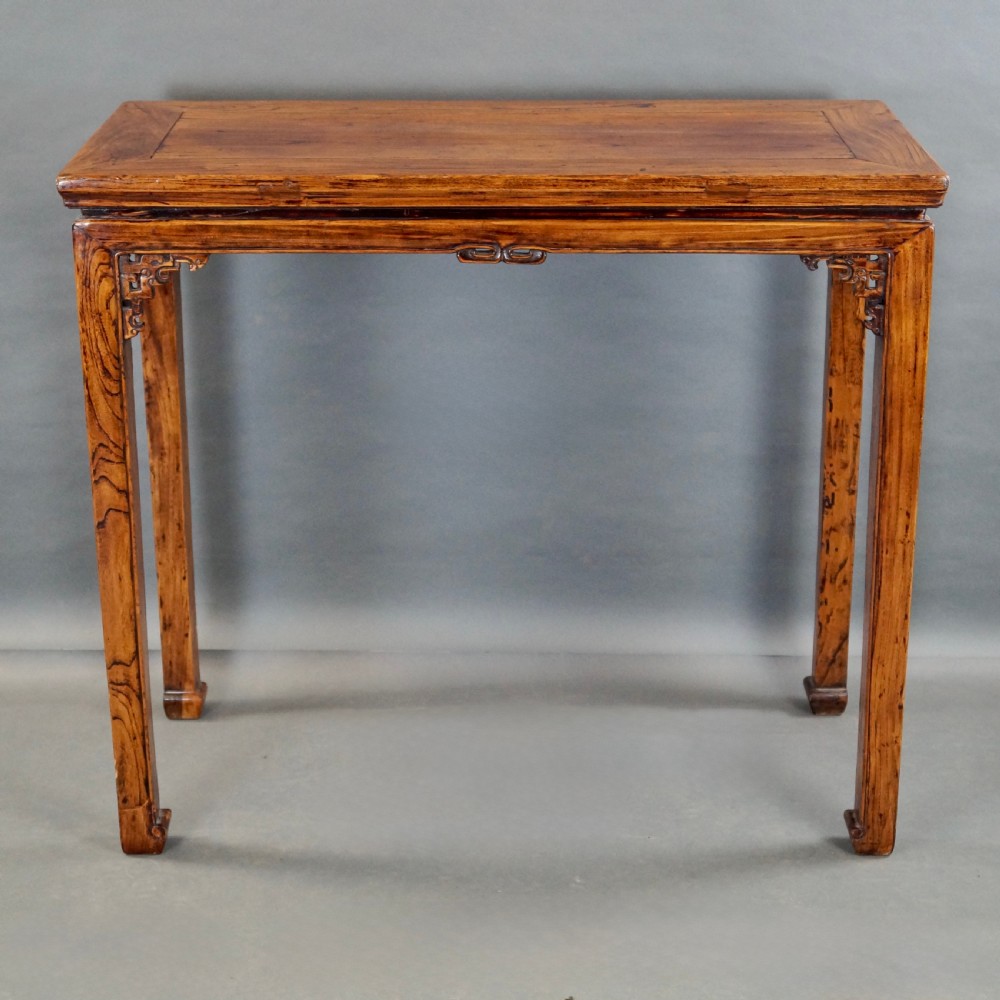 A pair of 19th-century Chinese elm side tables featuring rectangular floating panel tops, carved corner spandrels, and tall straight legs. View VII