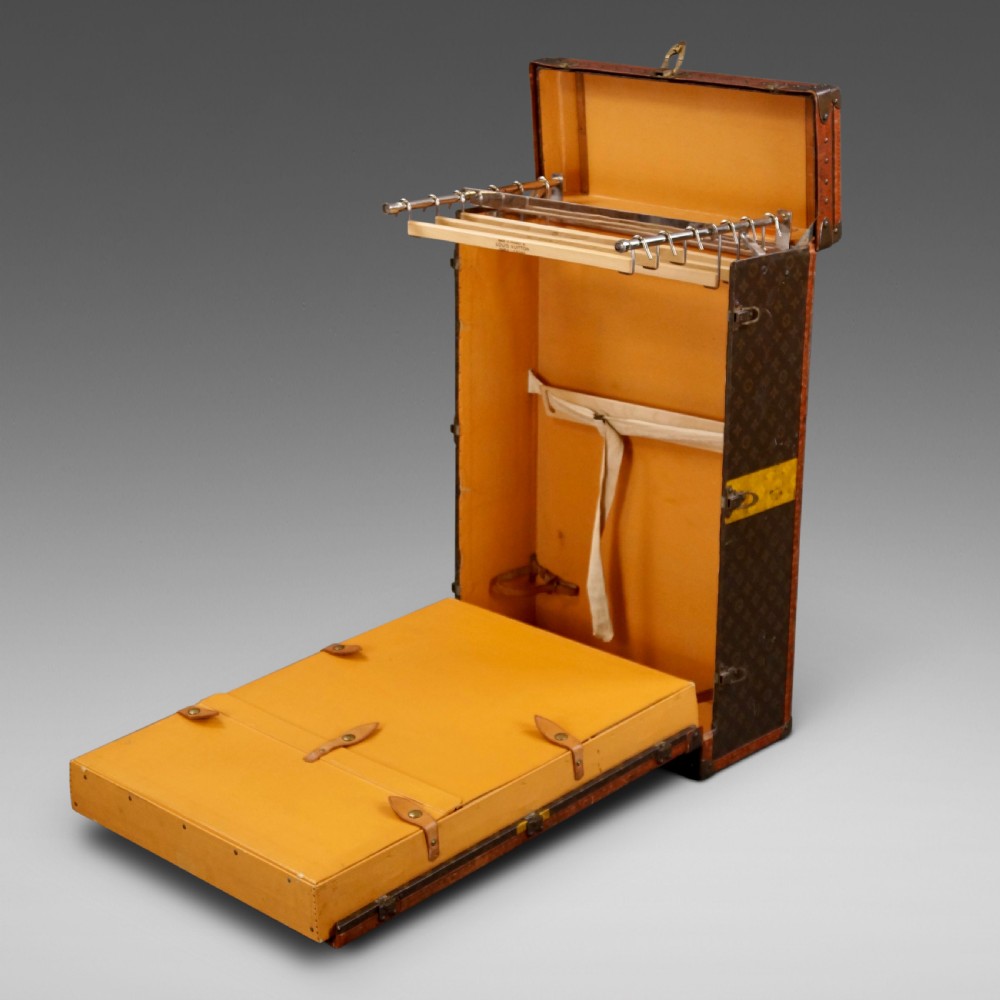 An upright 1930s Louis Vuitton monogram canvas wardrobe trunk featuring leather trim, brass hardware, and custom yellow painted stripes. View II