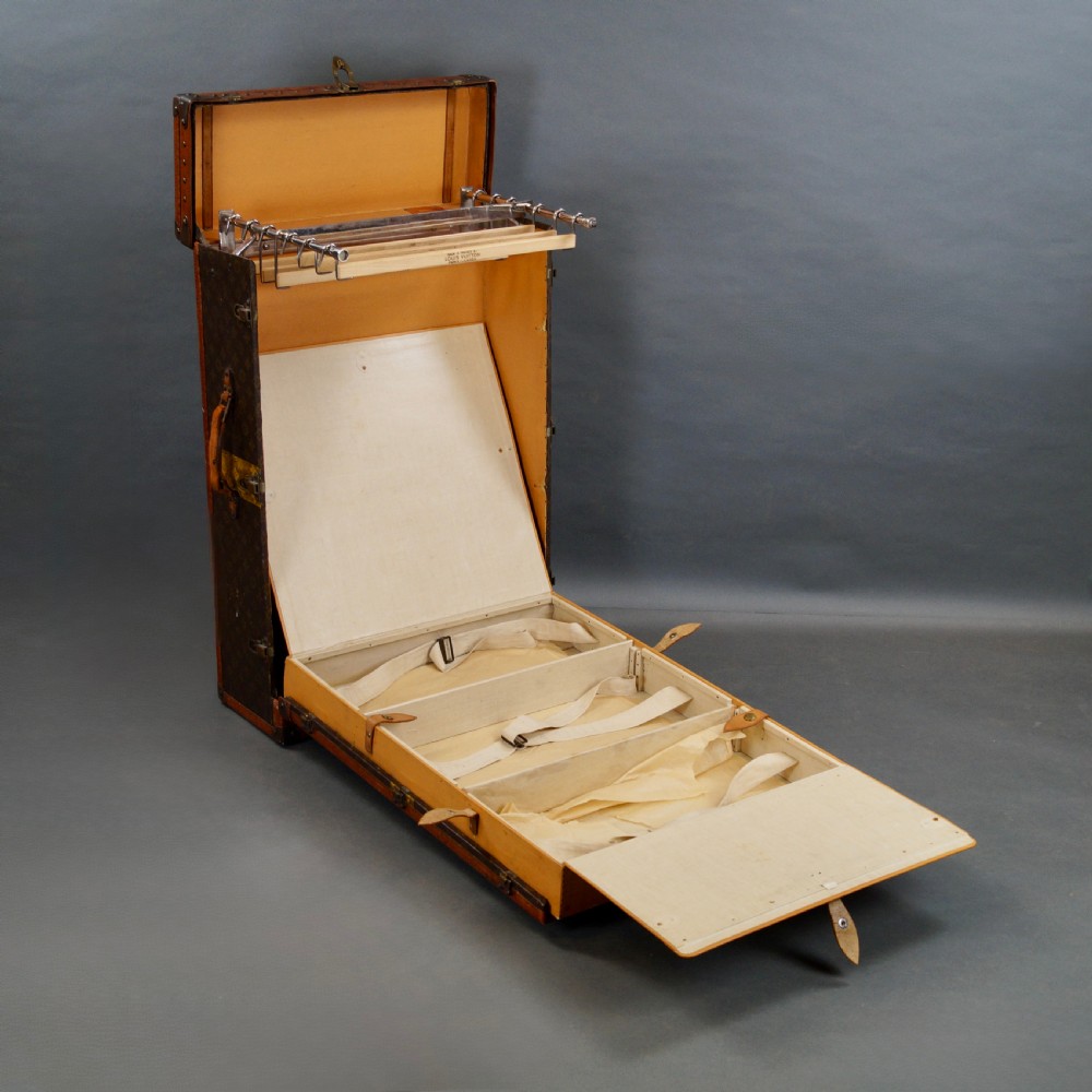 An upright 1930s Louis Vuitton monogram canvas wardrobe trunk featuring leather trim, brass hardware, and custom yellow painted stripes. View IX