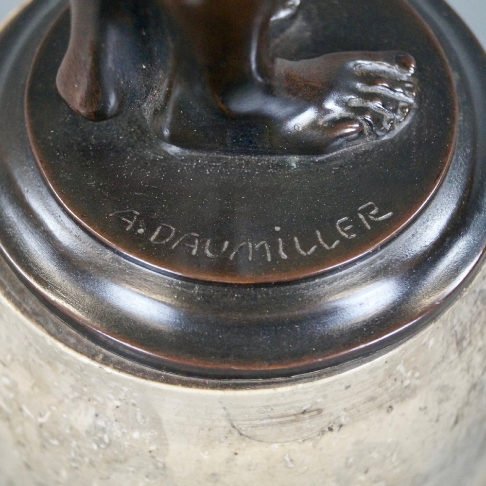 An Art Deco dark bronze sculpture depicting a standing female nude holding a small frog, mounted on a cylindrical veined marble pedestal base. View VII