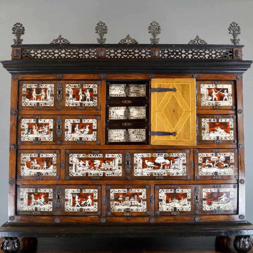 A 19th-century Portuguese cabinet on stand featuring inlaid bone figurative scenes, multiple drawer fronts surrounding a central arch, and a stand supported by dark spiral-turned legs. View III