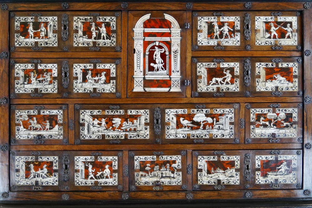 A 19th-century Portuguese cabinet on stand featuring inlaid bone figurative scenes, multiple drawer fronts surrounding a central arch, and a stand supported by dark spiral-turned legs. View VII