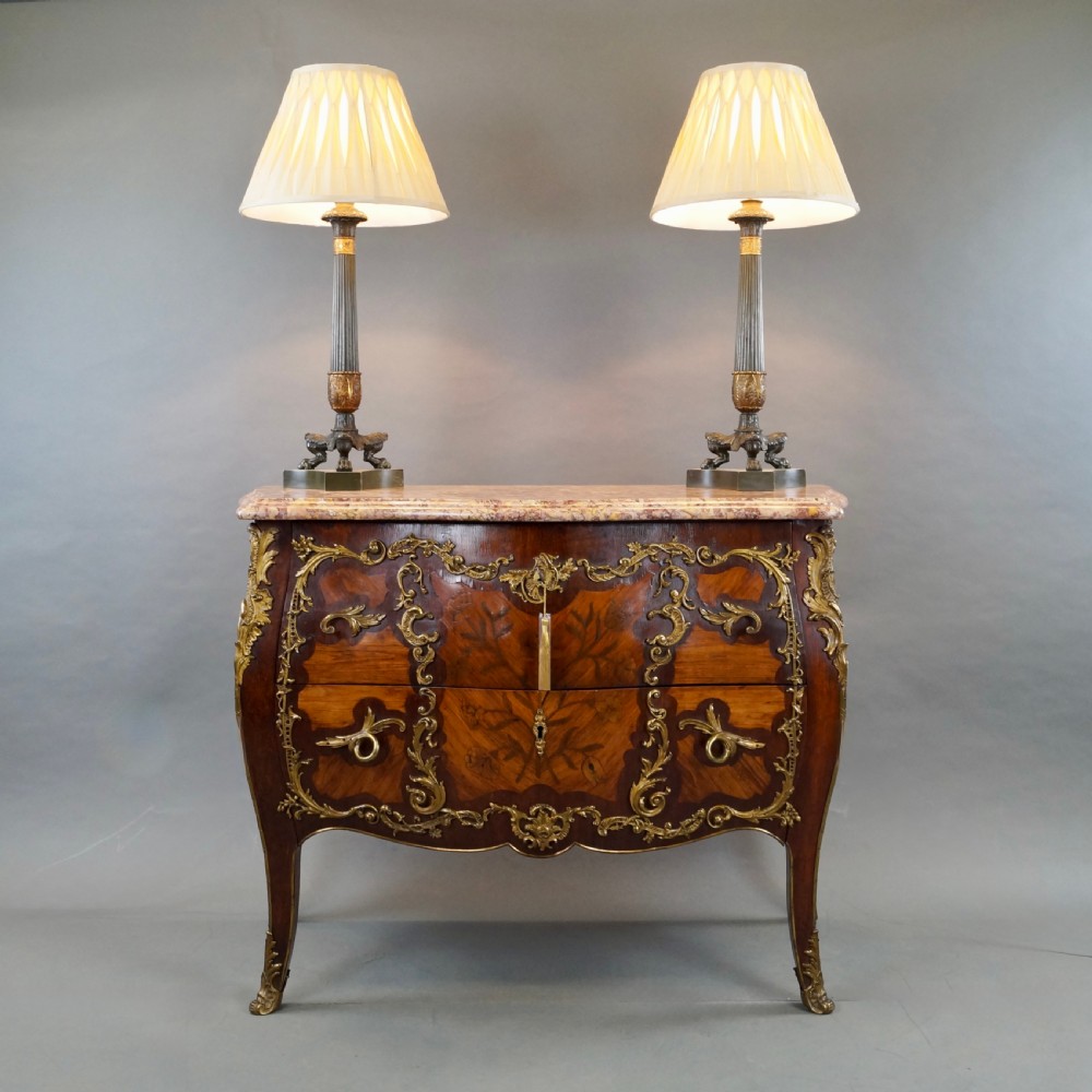 A pair of Neoclassical style dark patinated bronze table lamps featuring fluted columns, gilt bronze mounts, paw feet, and cream pleated shades. View II