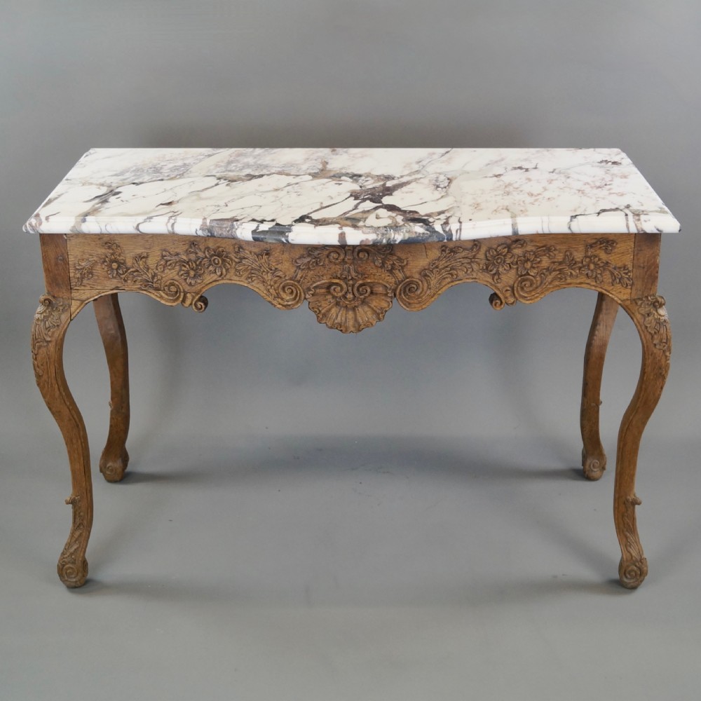 A late 18th-century carved oak console table with cabriole legs, a floral frieze, a shell motif, and a grey-veined white marble top. View II
