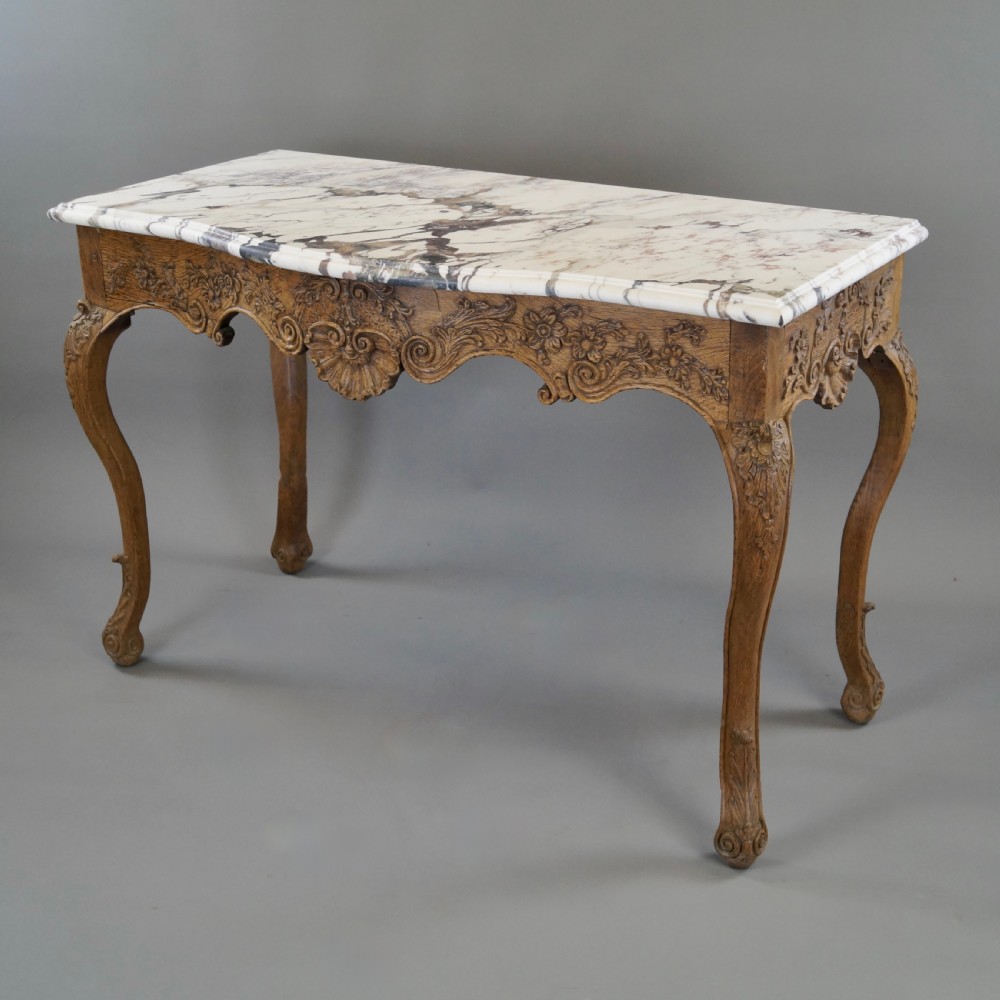 A late 18th-century carved oak console table with cabriole legs, a floral frieze, a shell motif, and a grey-veined white marble top. View III