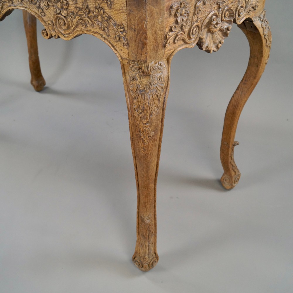 A late 18th-century carved oak console table with cabriole legs, a floral frieze, a shell motif, and a grey-veined white marble top. View V