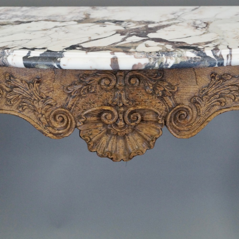 A late 18th-century carved oak console table with cabriole legs, a floral frieze, a shell motif, and a grey-veined white marble top. View VI