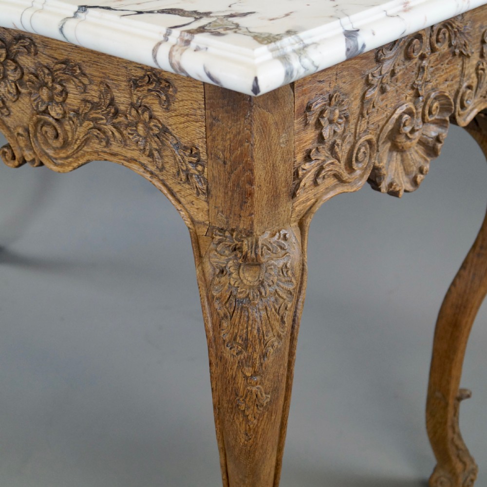 A late 18th-century carved oak console table with cabriole legs, a floral frieze, a shell motif, and a grey-veined white marble top. View VII