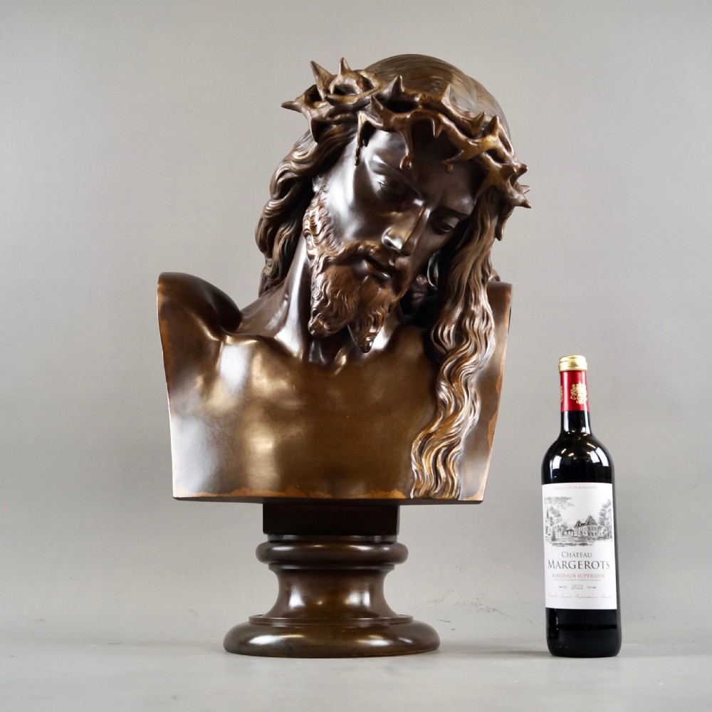 A large dark patinated bronze bust depicting Jesus Christ wearing the Crown of Thorns, mounted on a turned pedestal. View II
