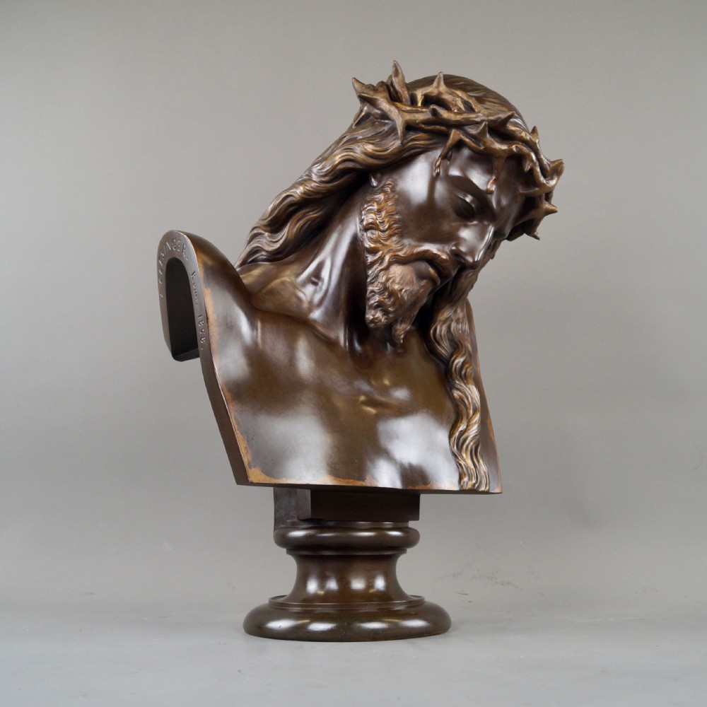 A large dark patinated bronze bust depicting Jesus Christ wearing the Crown of Thorns, mounted on a turned pedestal. View III