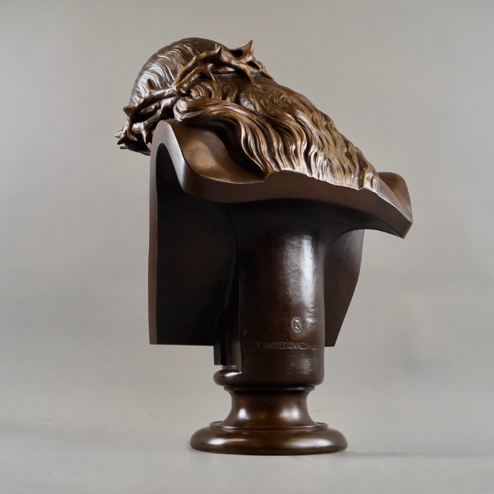 A large dark patinated bronze bust depicting Jesus Christ wearing the Crown of Thorns, mounted on a turned pedestal. View V