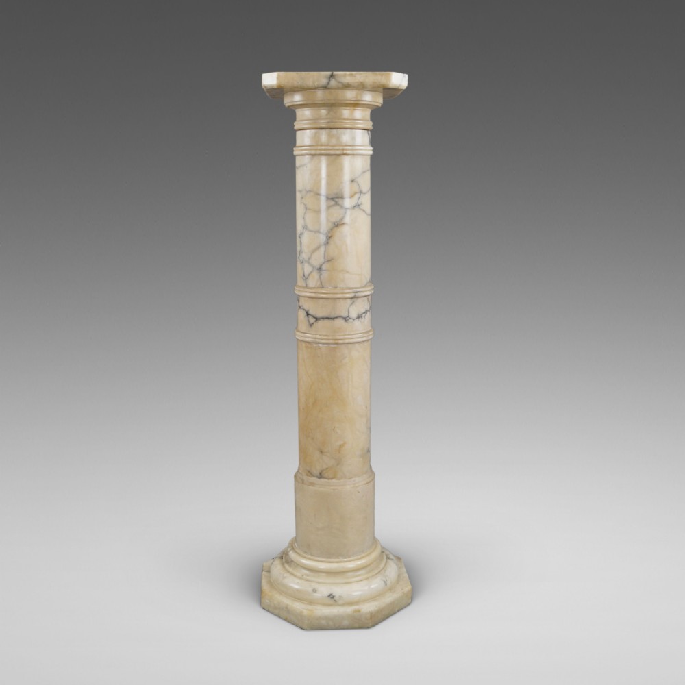 A Neoclassical Arabescato marble column featuring grey veining, a moulded square capital, a cylindrical shaft, and an octagonal base.