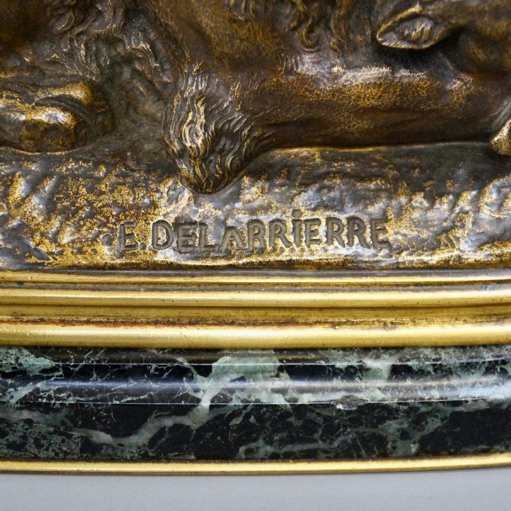 A nineteenth-century French gilded bronze sculpture of a recumbent lion with prey, set upon a moulded green marble plinth. View VIII