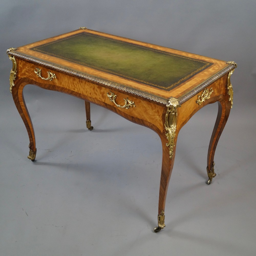 A pair of Louis XV style bureau plat writing desks featuring satinwood marquetry, green leather tops, cabriole legs, and elaborate gilt-bronze mounts. View II