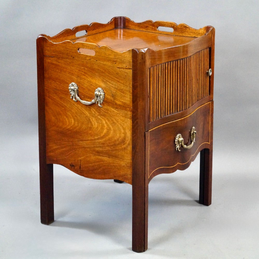 A Georgian mahogany tray-top commode featuring a galleried rim with cut-out handles, a slatted tambour door, and a lower serpentine drawer with brass pulls. View III