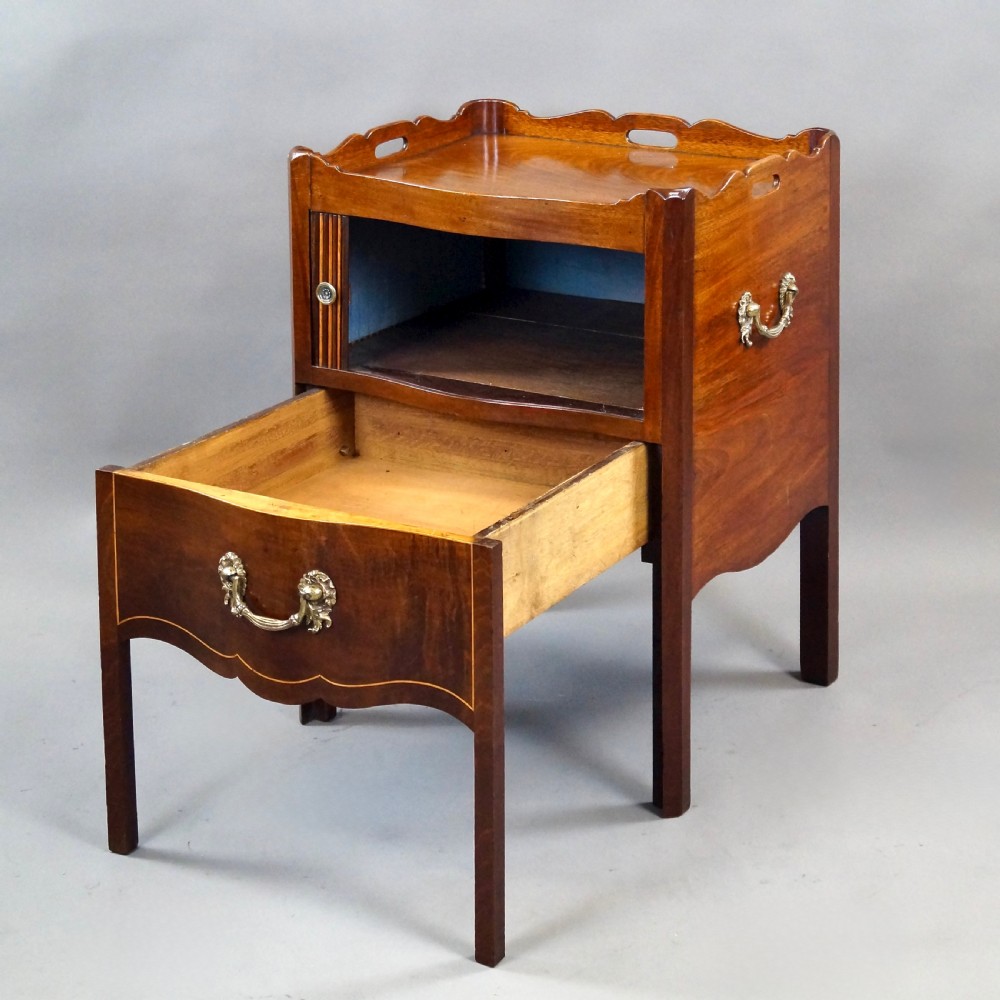 A Georgian mahogany tray-top commode featuring a galleried rim with cut-out handles, a slatted tambour door, and a lower serpentine drawer with brass pulls. View V