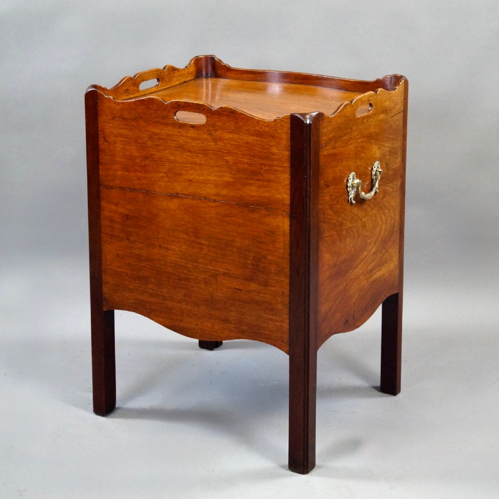 A Georgian mahogany tray-top commode featuring a galleried rim with cut-out handles, a slatted tambour door, and a lower serpentine drawer with brass pulls. View VI