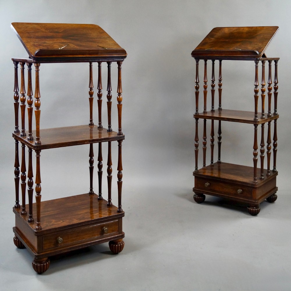 A pair of antique rosewood tiered whatnots featuring adjustable sloped reading tops, turned spindle supports, single drawers at the base, and lobed bun feet. View III
