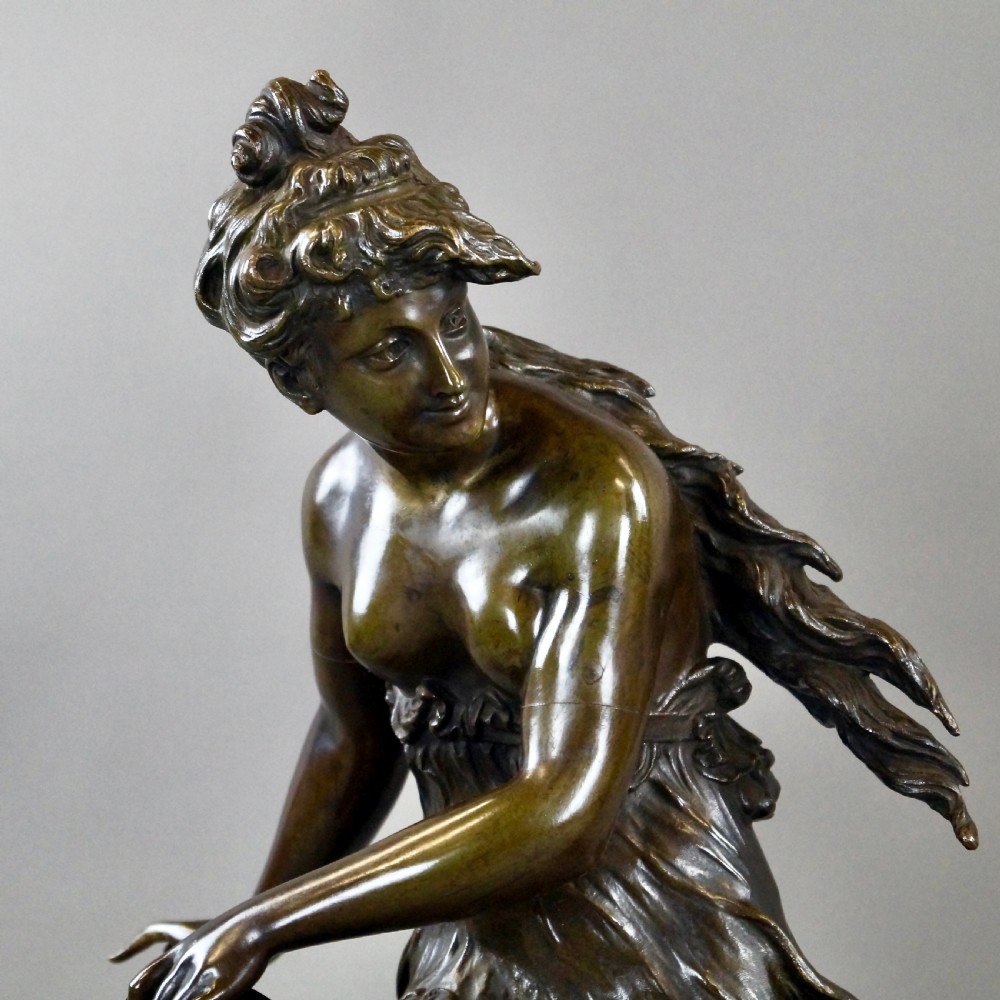 A pair of 19th-century dark bronze sculptures depicting a female musician with a tambourine and a male figure playing a lute, both set on circular red marble bases. View IV