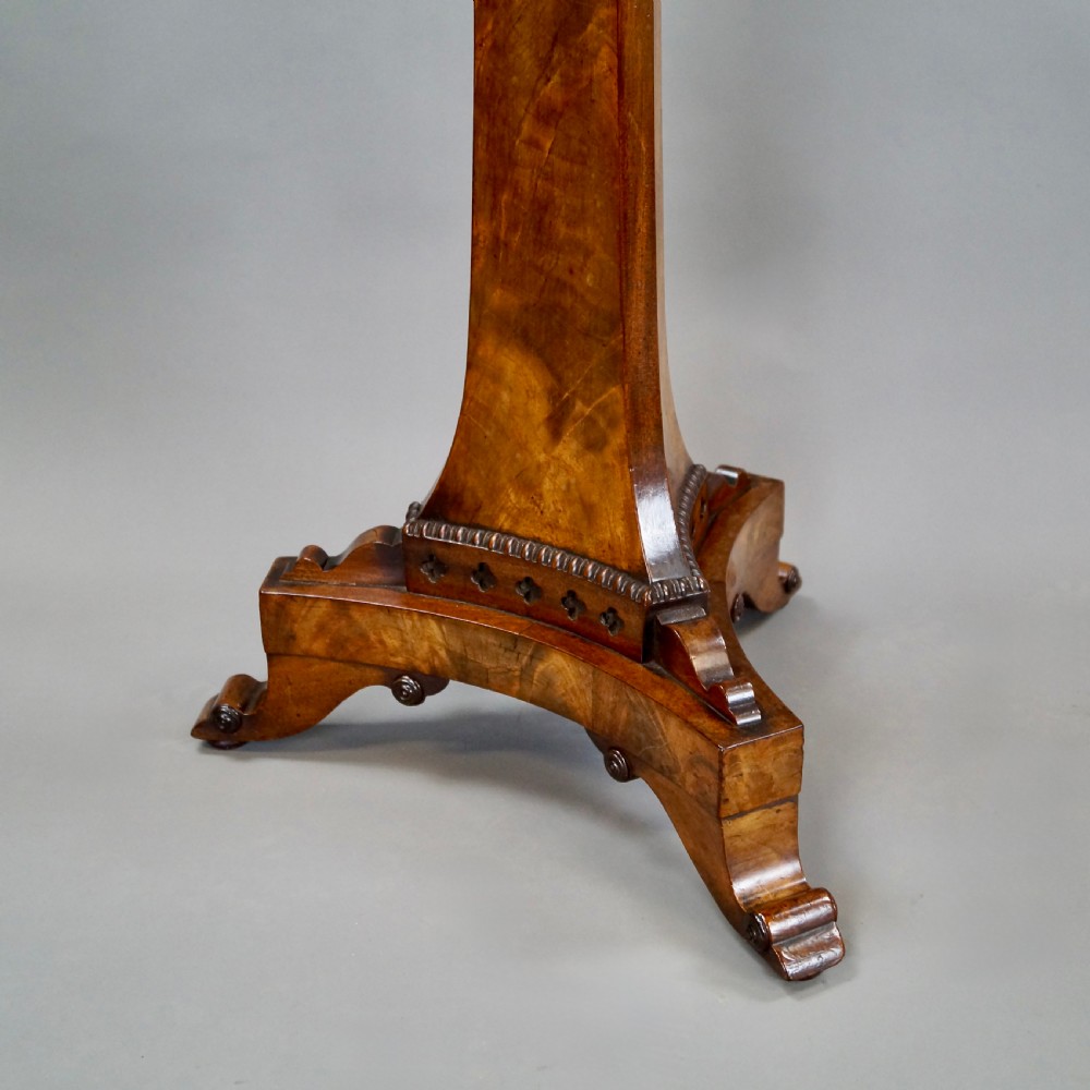 A William IV mahogany circular chess table with an inlaid board, tapered central stem, and triform base on scroll feet. View V