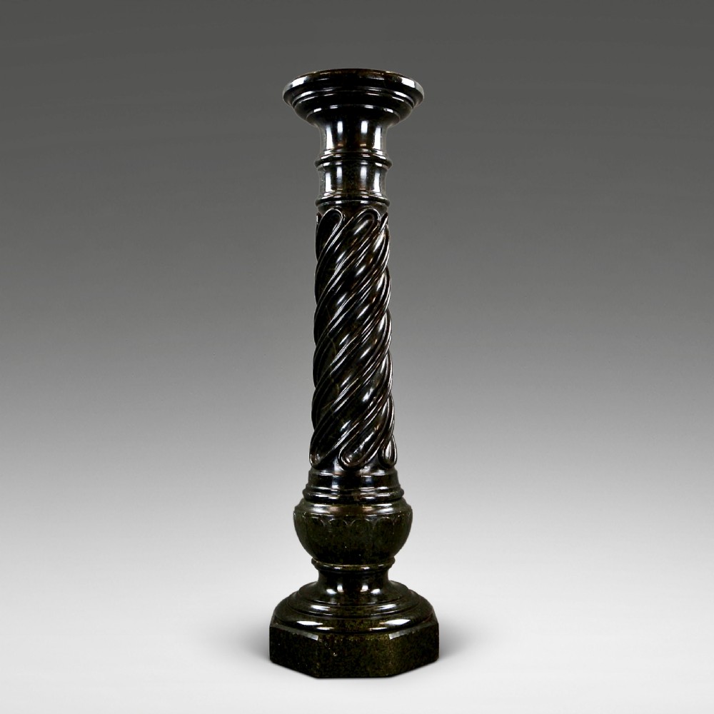 A mid-nineteenth-century French dark green Verde Antico marble column with a carved barley twist shaft and octagonal base.