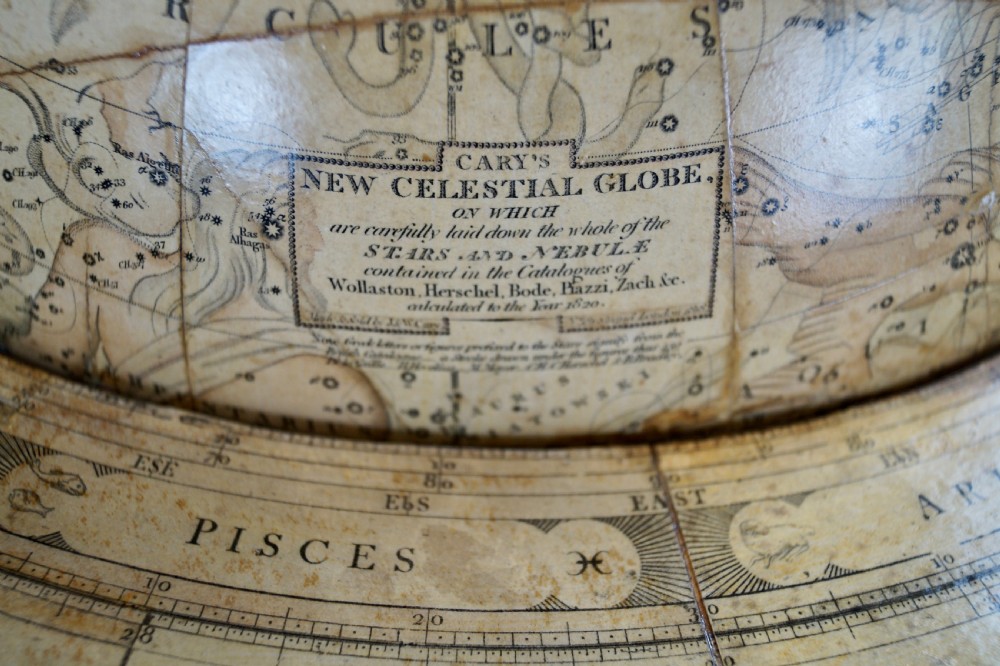 A pair of floor-standing antique globes on turned mahogany reeded legs with brass meridian rings and integral compasses set into the lower stretchers. View VI