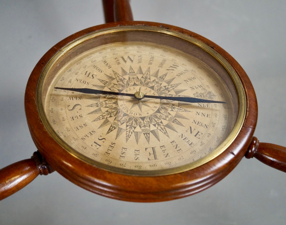A pair of floor-standing antique globes on turned mahogany reeded legs with brass meridian rings and integral compasses set into the lower stretchers. View VII
